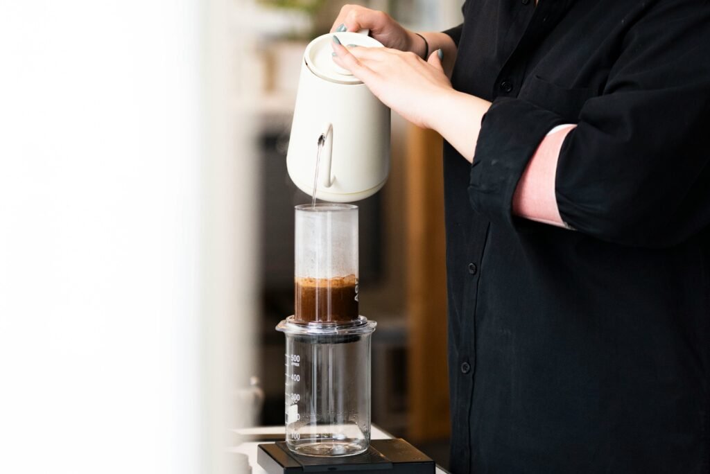 Image is representing water is being poured in aeropress to brew coffee, brew guide, coffee brew help with aeropress by five roam coffee